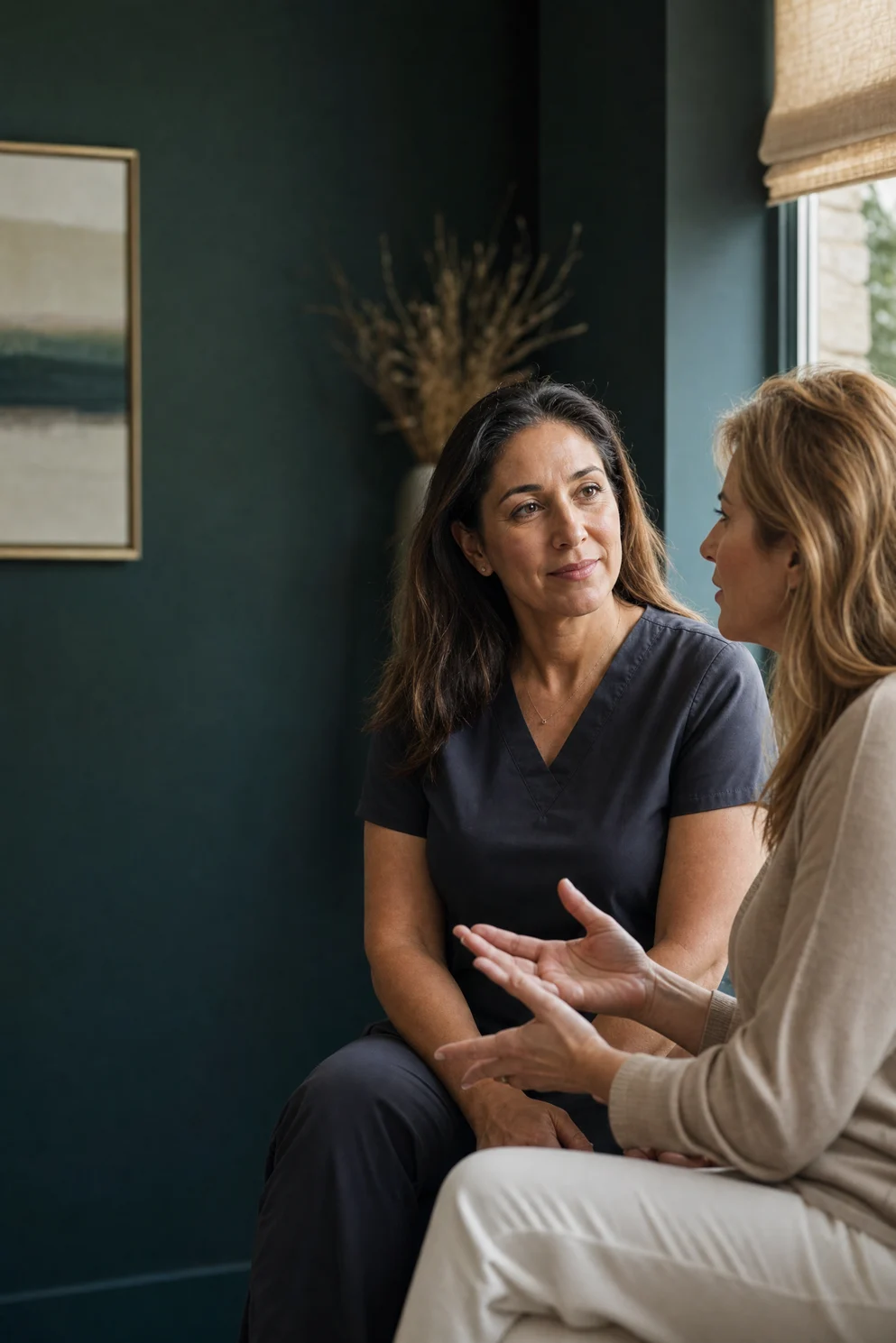 Clinician speaking with a woman during a private hormone-care consultation